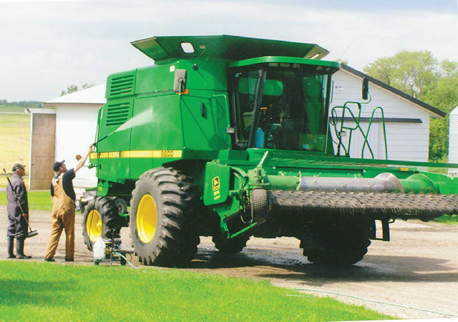 Mark McCorriston and his father, Lorne, washing one their combines after harvest back in 2010.